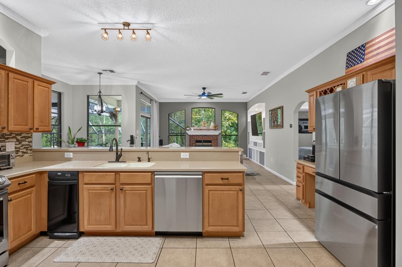 Kitchen sink area open to the living room at 2125 Blue Heron Cove Dr, Orange Park, FL 32003