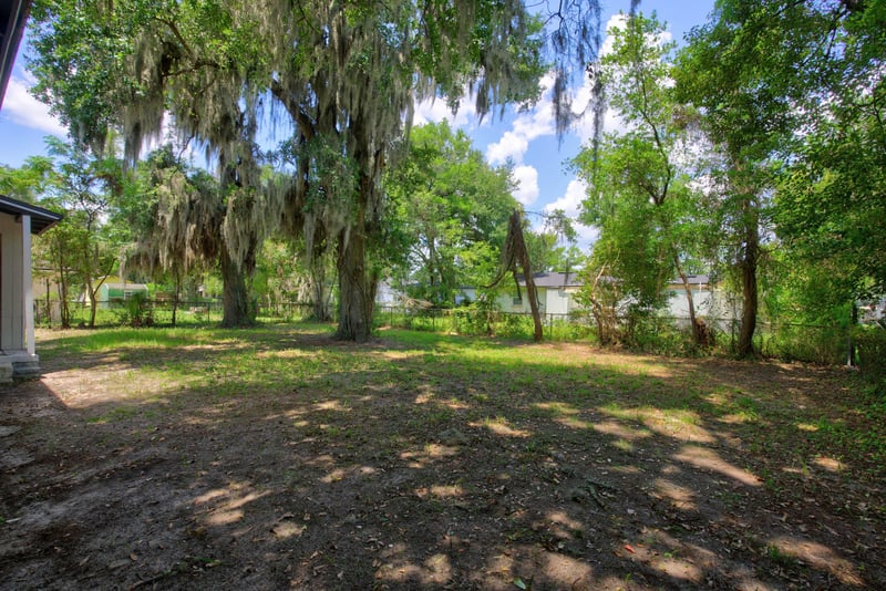 Open backyard lawn with trees at 855 Cornwallis Dr, Jacksonville, FL