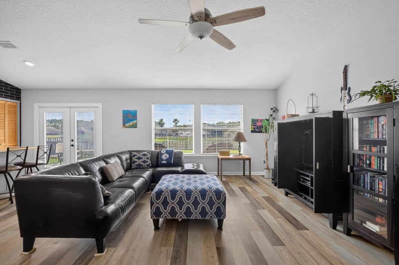 Living room with leather sofa and multiple windows at 2065 Creekmont Dr