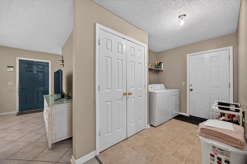 Laundry area with washer and side door at 5375 Dodge Rd, Jacksonville, FL 32209