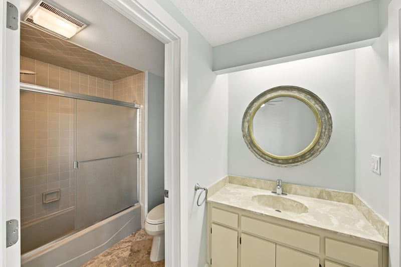 Bathroom with glass shower and round mirror at 752 Spinnakers Reach Dr, Ponte Vedra Beach, FL 32082