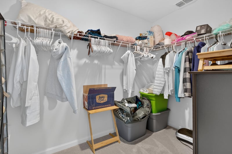 Primary walk-in closet with hanging rods at 1186 Beach Dune Dr, Jacksonville, FL 32233