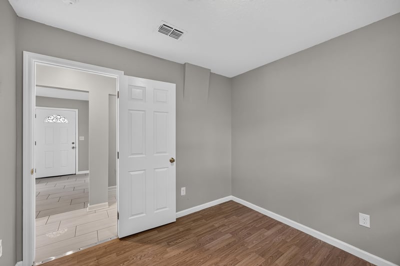 Hallway with doors and tile floor at 7015 Miss Muffet Ln N, Jacksonville, FL 32210