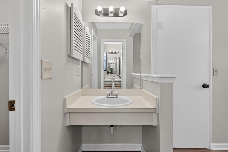 Bathroom vanity with mirror at 8010 International Village Dr, Jacksonville, FL 32277