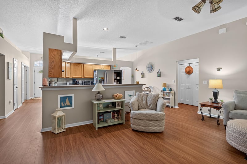 Kitchen island with open-concept living room beyond at 13514 Las Brisas Way N, Jacksonville, FL