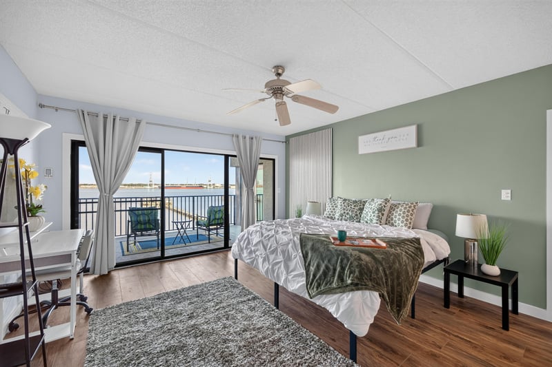 Bedroom with green accent wall and balcony access at 2280 Shepard St