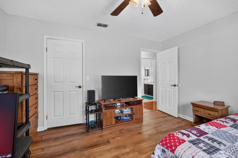 Bedroom with television stand and wood flooring at 2435 Range Line Rd, Middleburg, FL