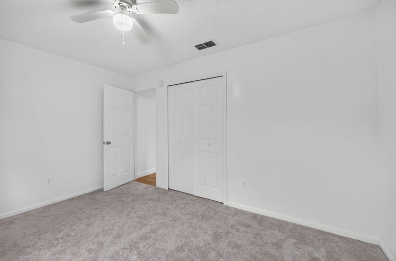 Empty carpeted room at 8921 Needlepoint Pl, Jacksonville, FL 32244