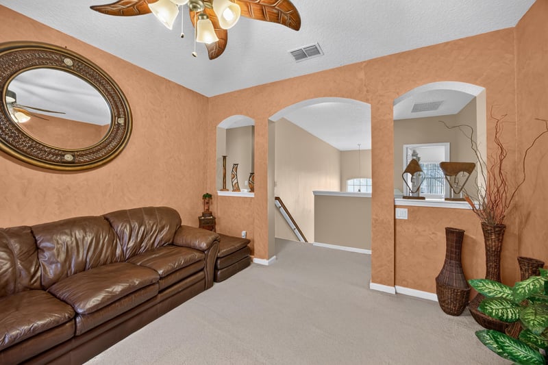 Living room with vaulted ceiling and archway at 2875 Pebblewood Ln, Orange Park, FL 32065