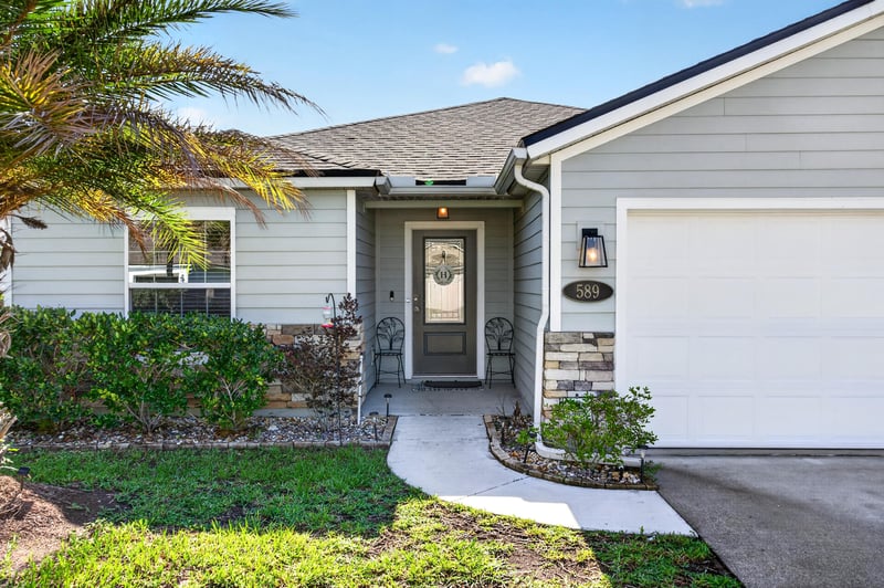 Front entry with stone accent and garage door at 589 Seville Pkwy, St. Augustine, FL