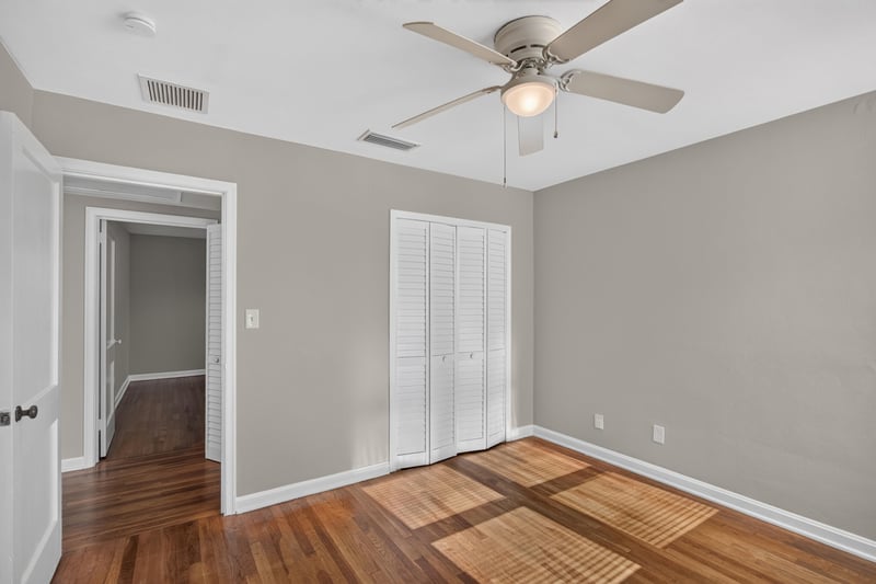 Bedroom with closet doors and hardwood floors at 6338 Mercer Cir W, Jacksonville, FL