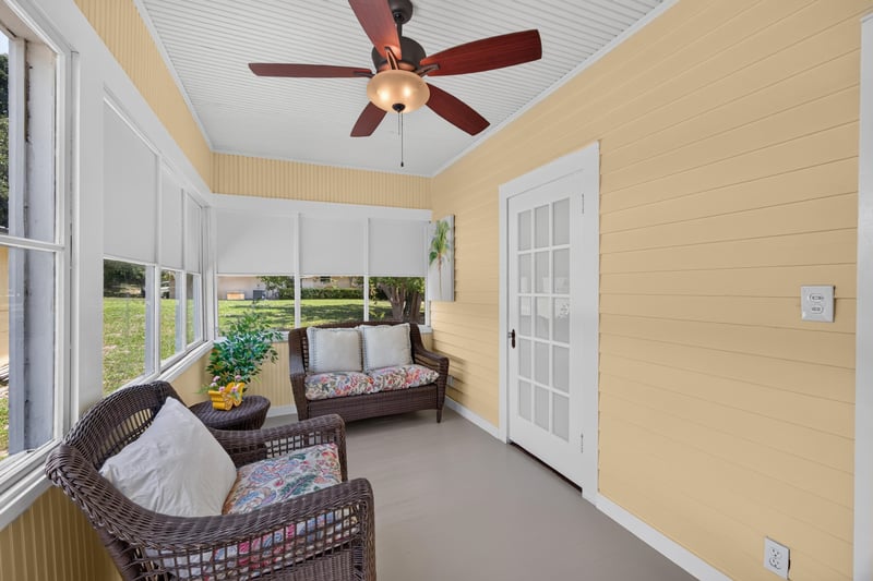 Sunroom with wicker loveseat at 101 N Lake St, Crescent City, FL
