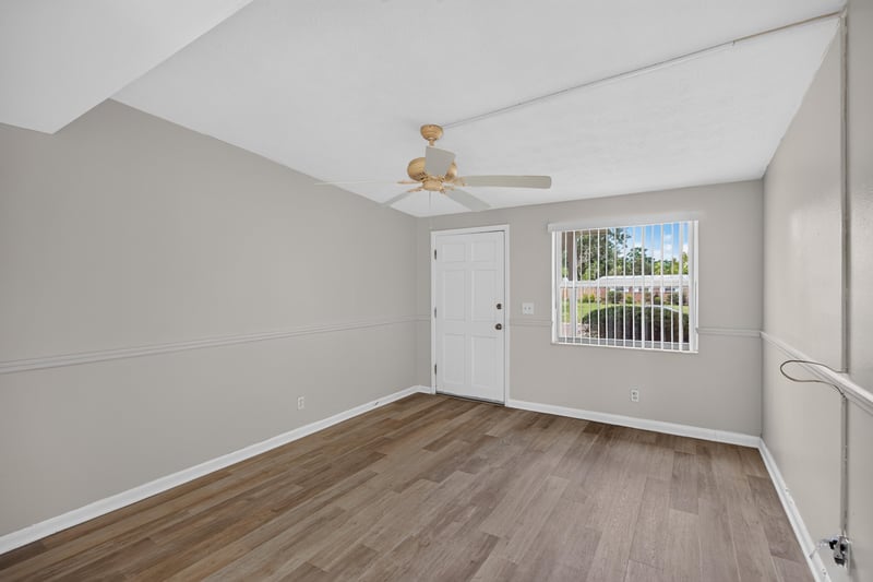 Living room with wood floor and window at 87 Saratoga Cir S, Atlantic Beach, FL