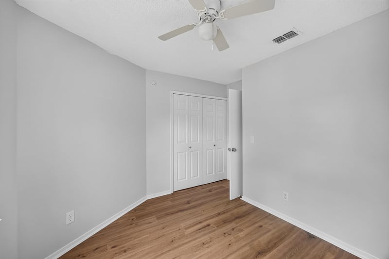 Bedroom with closet and wood floors at 8047 Mactavish Way E, Jacksonville, FL 32244
