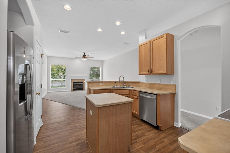 Kitchen with center island and stainless refrigerator at 2480 Ridge Will Dr, Jacksonville, FL 32246