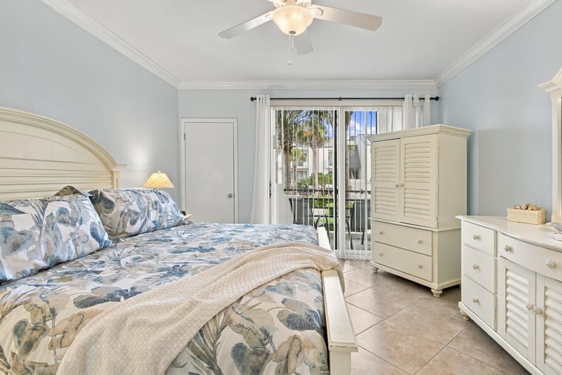 Bedroom with floral bedding and balcony door at 805 Spinnakers Reach Dr, Ponte Vedra Beach, FL 32082