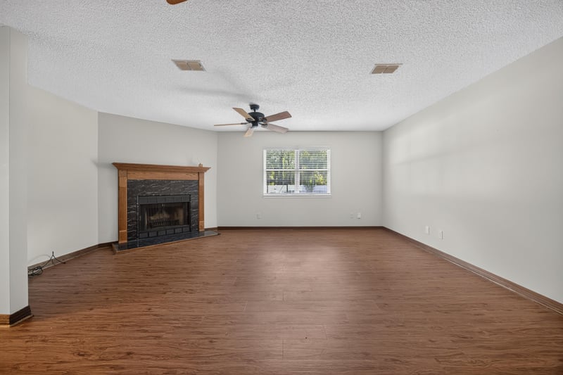 Family room with brick fireplace and wood floors at 892 Branscomb Rd, Green Cove Springs, FL