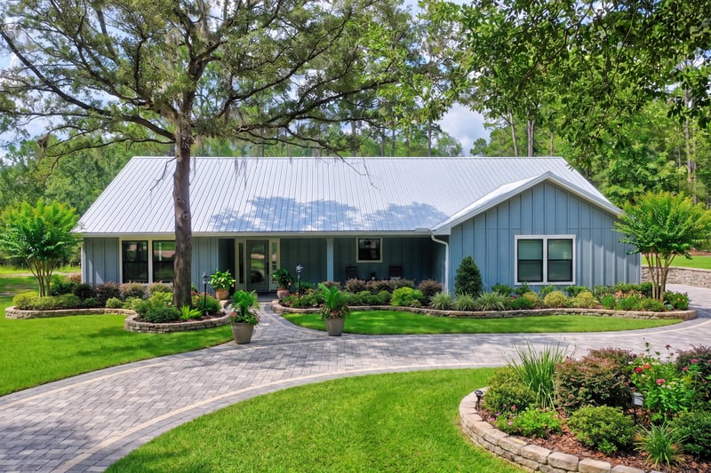 Front exterior with covered porch and landscaped beds at 4800 Acacia St, Middleburg, FL 32068
