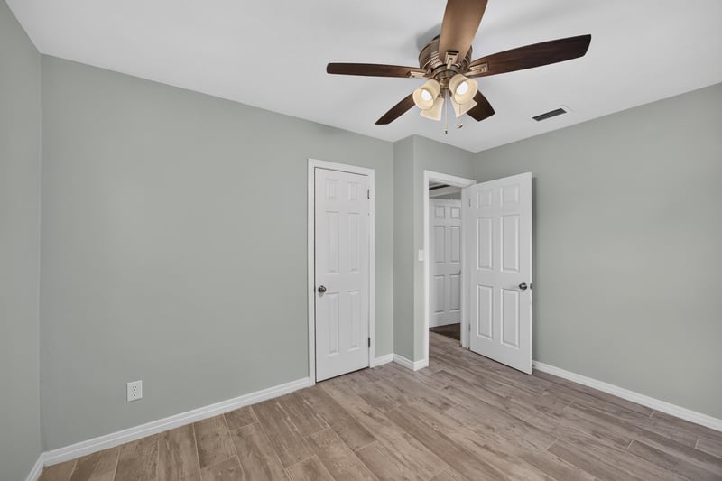 Bedroom, wood-look floors and two doors at 2256 Inwood Cir S, Jacksonville, FL