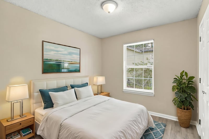 Bedroom with bed and nightstand lamps, staged, at 219 Shortreed St, Jacksonville, FL 32254