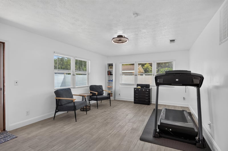 Flex room with treadmill and seating by windows at 6059 Karen St, Jacksonville, FL 32244