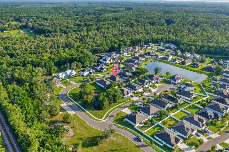 Wide aerial view of the subdivision with the home marked in Green Cove Springs, FL