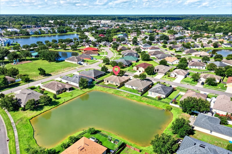 Aerial view of the home near a retention pond at 7545 Lirope St, Jacksonville, FL 32244