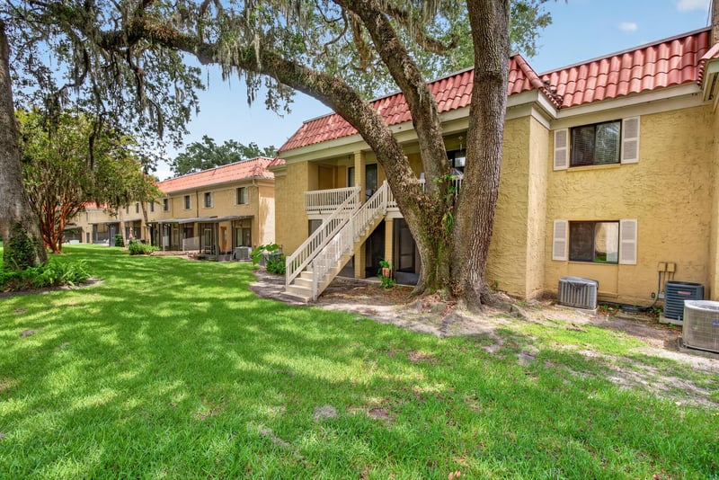 Courtyard lawn shaded by oak trees at 5811 Atlantic Blvd unit 47, Jacksonville, FL 32207