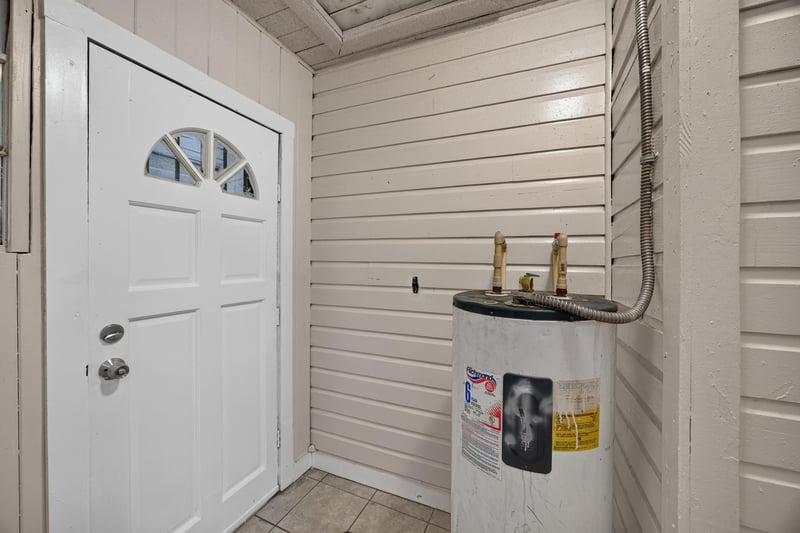 Back door entry with water heater and tile floor at 1473 State St W, Jacksonville, FL 32209