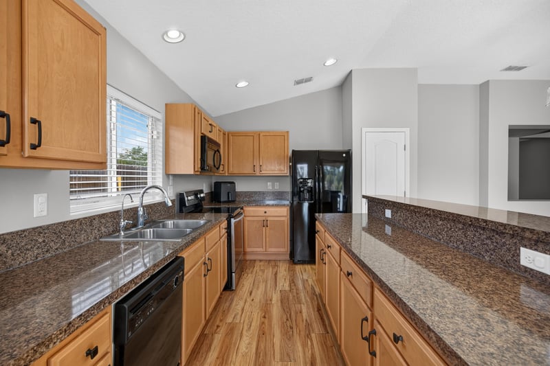 Kitchen counter with granite and cabinets at 7545 Lirope St, Jacksonville, FL 32244