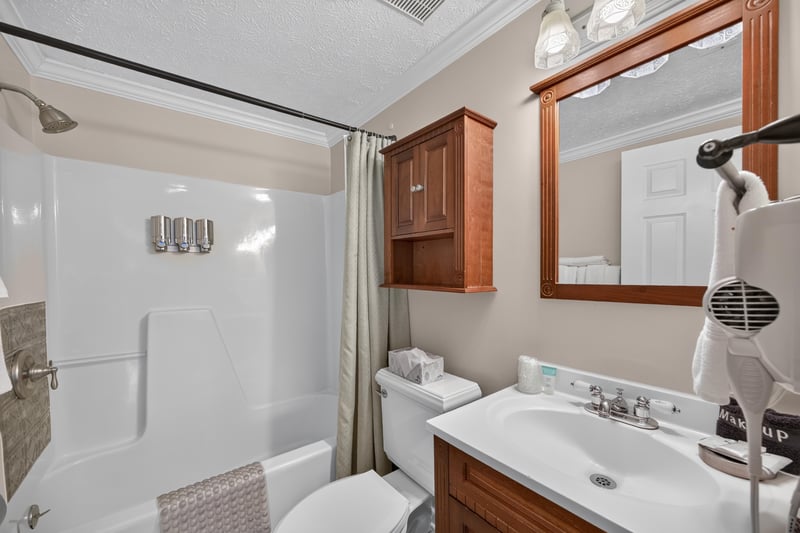 Bathroom with a walk-in shower and wood vanity at 115 Cordova St, St. Augustine, FL