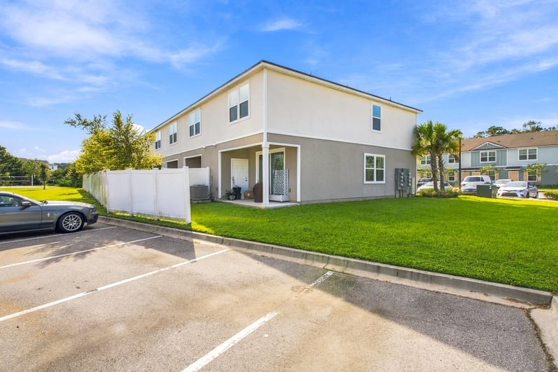 Side exterior with parking and grass area at 8359 Zenith Cir, Jacksonville, FL 32256