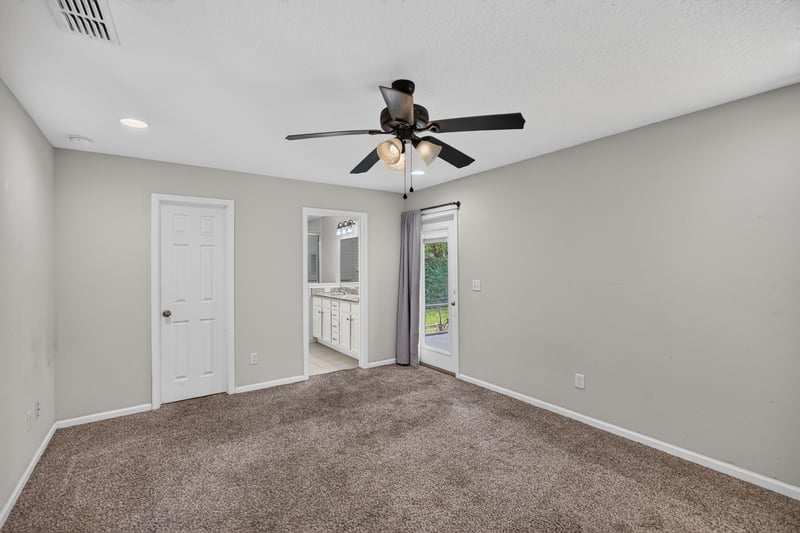 Empty carpeted room with ceiling fan and closet doors at 1002 Ingleside Ave, Jacksonville, FL 32205