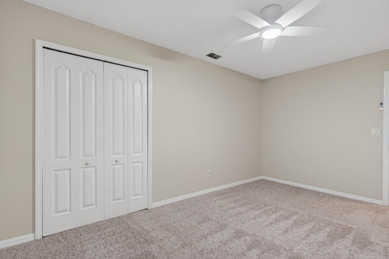 Bedroom with carpet and double closet doors at 1648 Glen Laurel Dr, Middleburg, FL 32068