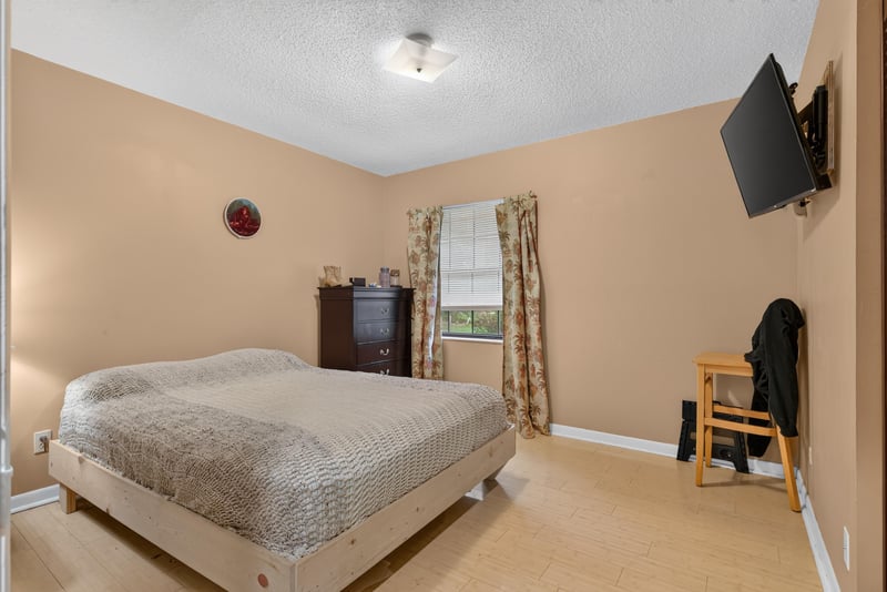Bedroom with bed and wall-mounted television at 3249 Maryland Ave, Green Cove Springs, FL