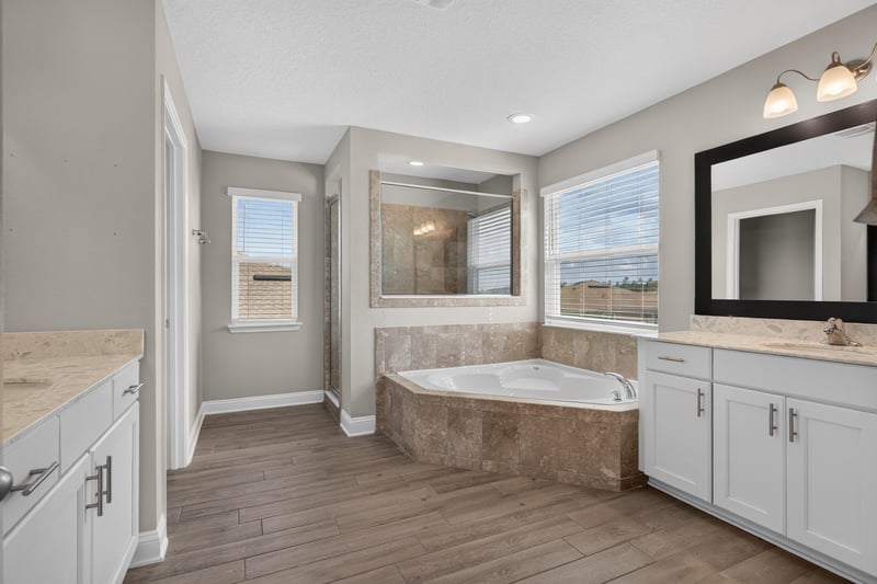 Primary bathroom with soaking tub and dual vanity at 2580 Cold Stream Ln, Green Cove Springs, FL 32043
