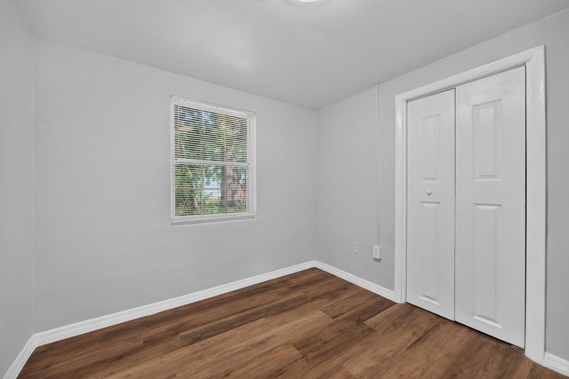 Bedroom with window and closet doors at 4951 Halls Dr