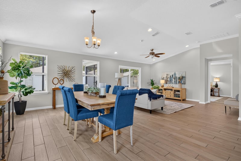 Open dining and living space with wood flooring at 10066 Andean Fox Dr, Jacksonville, FL 32222