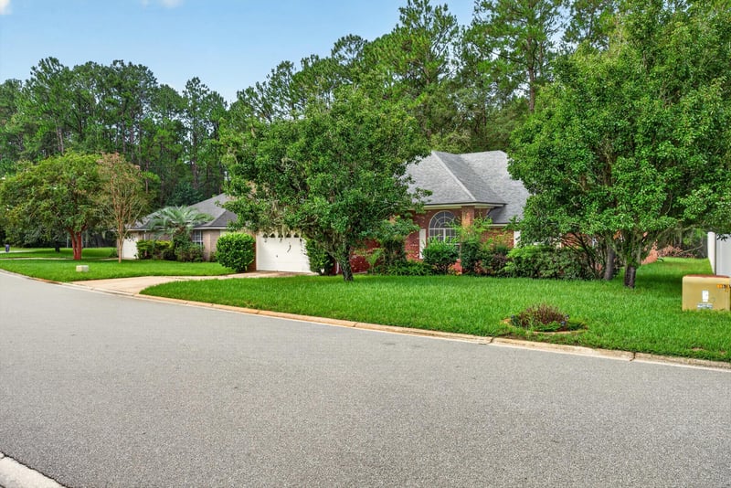 Front exterior view with driveway and lawn at 11669 Collins Creek Dr, Jacksonville, FL 32258