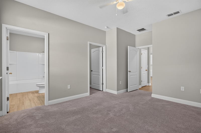 Hallway with multiple doors and carpet at 2580 Cold Stream Ln, Green Cove Springs, FL 32043