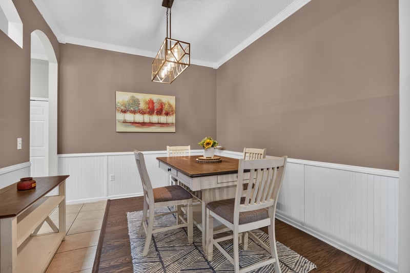 Dining room with wainscoting and table at 2125 Blue Heron Cove Dr, Orange Park, FL 32003