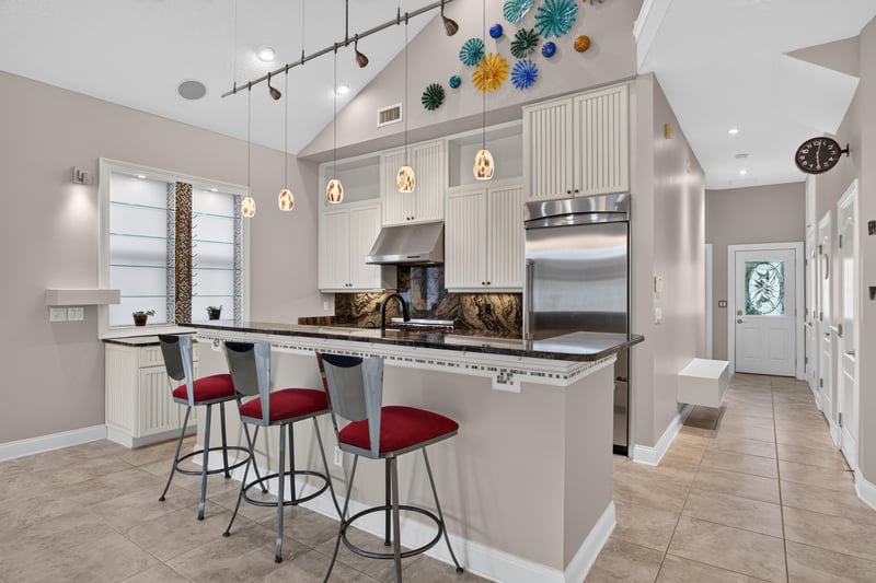 Kitchen island with bar stools at 117 Island Cottage Way, St. Augustine, FL 32080