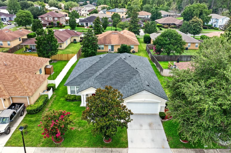 Aerial view of the home's tile roof and front yard at 2282 Justin Lake Dr, Jacksonville, FL