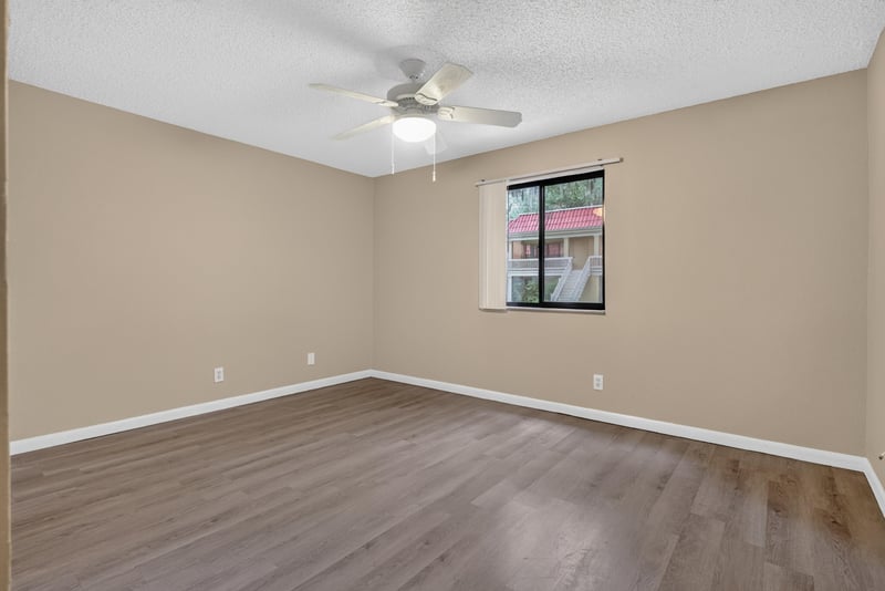 Empty bedroom with ceiling fan and window at 5811 Atlantic Blvd unit 47, Jacksonville, FL 32207