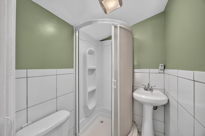 Bathroom with shower stall and pedestal sink at 2841 Ernest St, Jacksonville, FL 32205