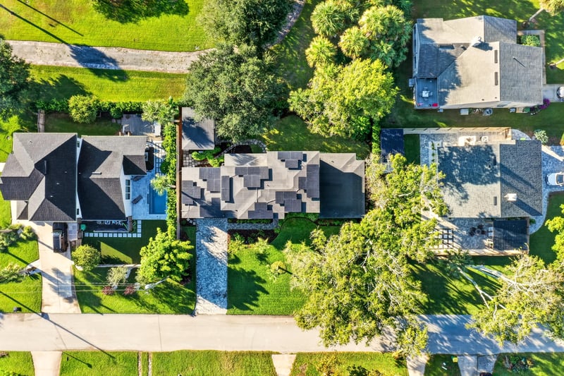 Aerial close view of rooftops and yards near the home in Jacksonville Beach, FL