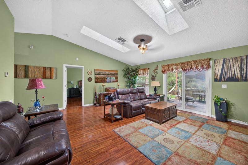 Family room with leather sofas and wood floors at 145 Dover Bluff Dr, Orange Park, FL