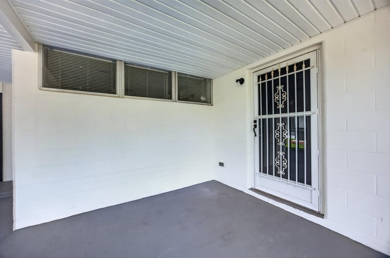 Covered porch with barred security door at 6238 Randia Dr, Jacksonville, FL 32210