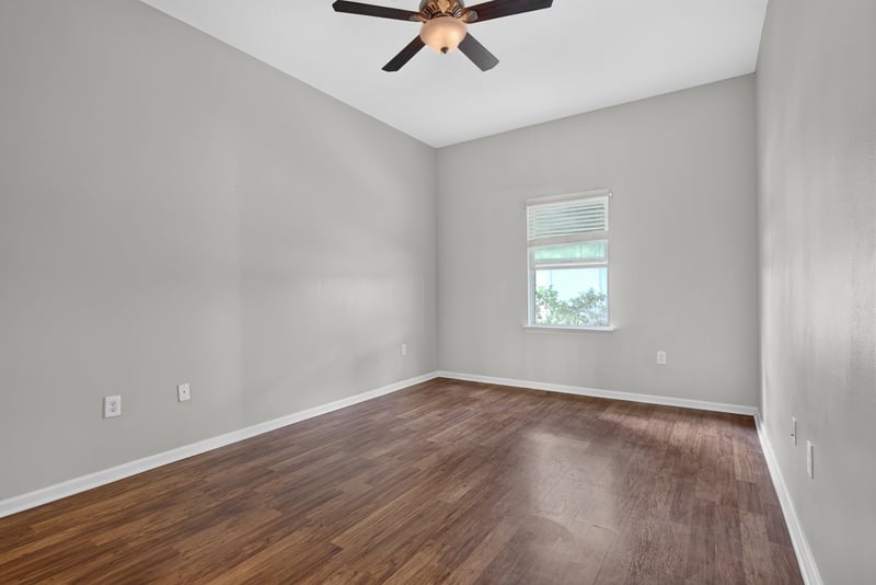 Bedroom with wood-look flooring and window at 8196 Cabin Lake Cir, Jacksonville, FL 32256