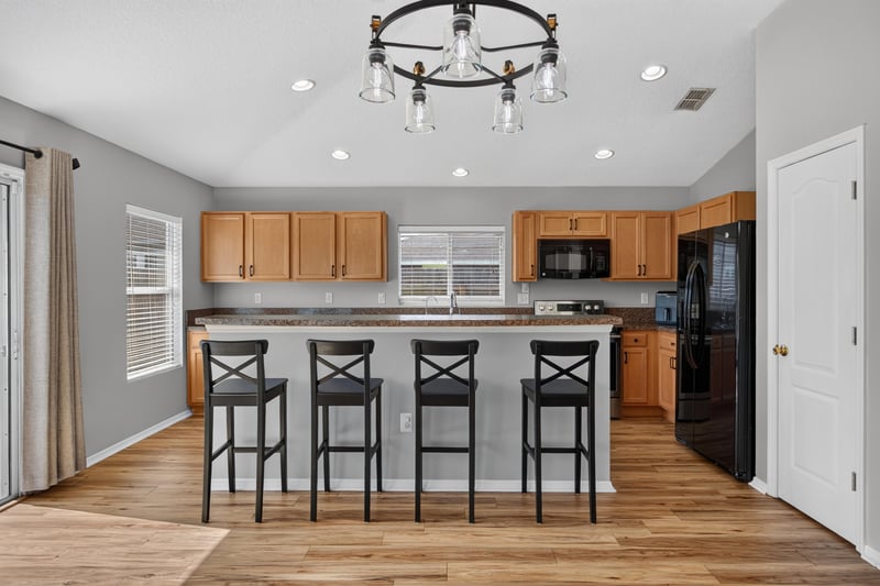 Kitchen island with black appliances at 7545 Lirope St, Jacksonville, FL 32244